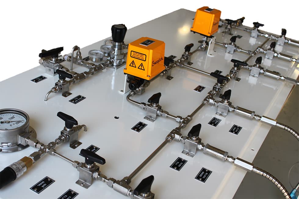A large panel under assembly, flat on a bench, with an orange actuator