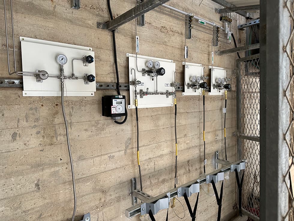 Outdoor concrete wall with three panels and cabling